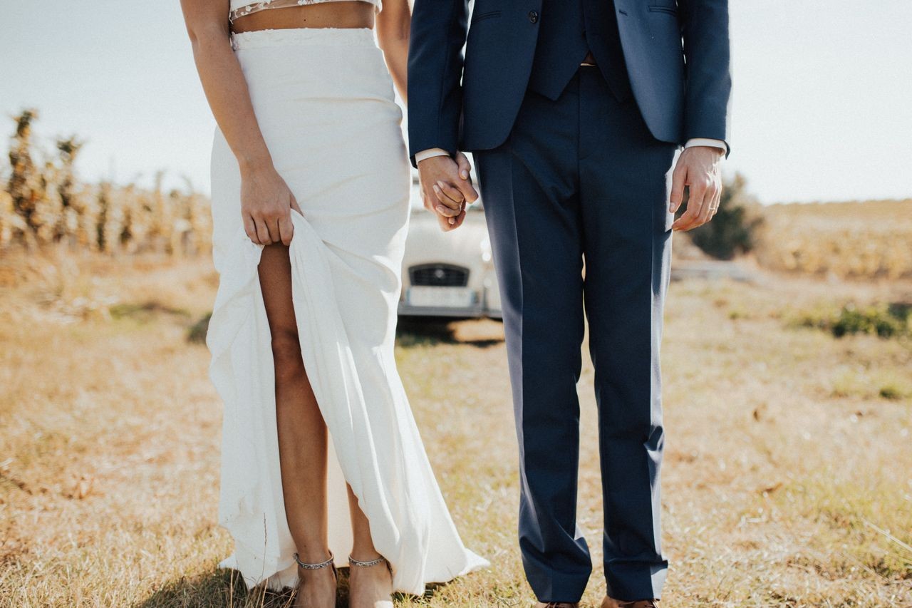 couple holding hands in a field couple holding hands in a field