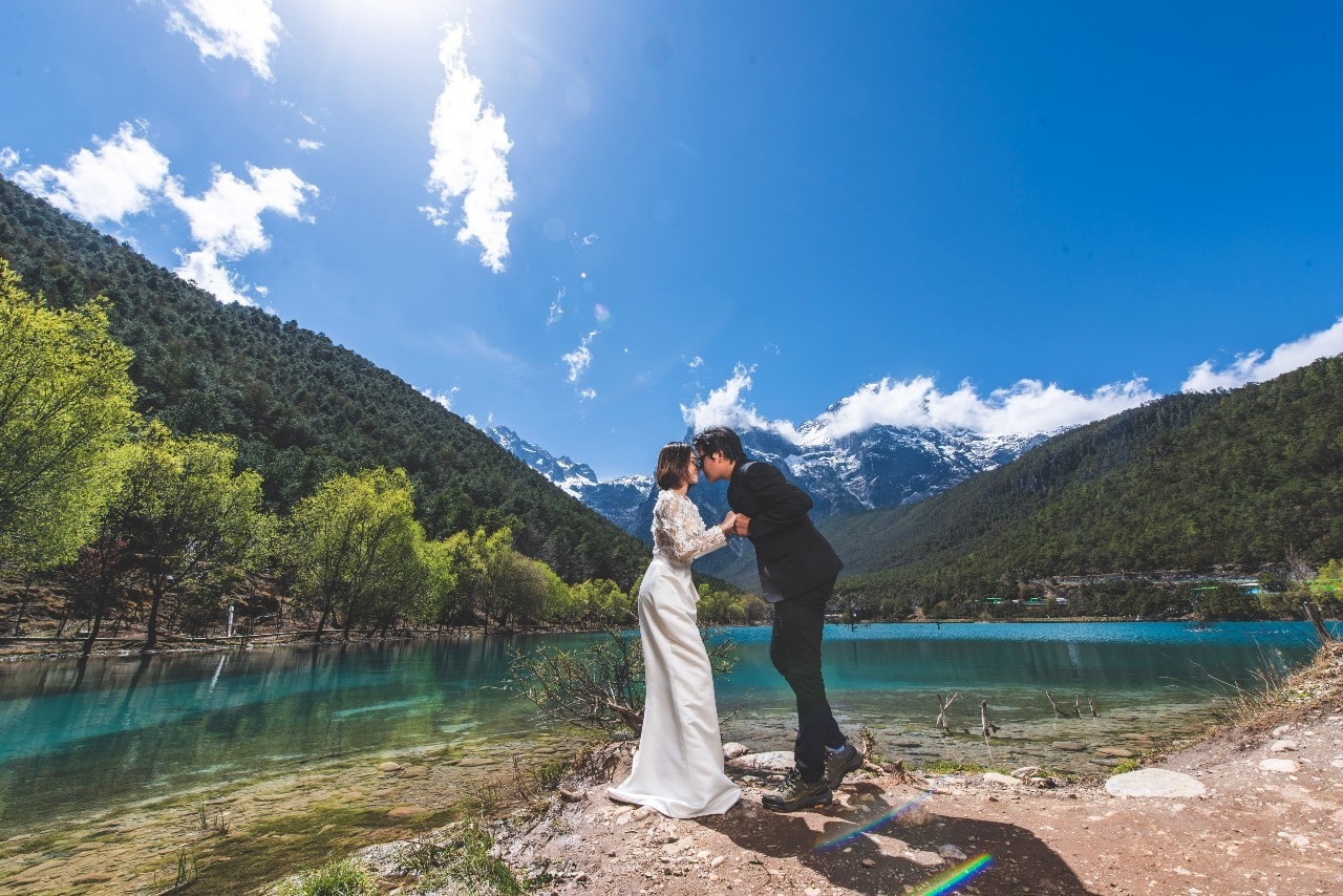 a married couple embracing in front of a scenic backdrop a married couple embracing in front of a scenic backdrop